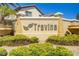 Community sign for Travina with manicured landscaping, shrubs, and flower pots at 236 Dog Leg Dr, Las Vegas, NV 89148