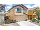 Two story home with a two-car garage and manicured gravel landscaping in the front yard at 236 Dog Leg Dr, Las Vegas, NV 89148