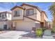Inviting two-story house with desert landscaping and an attached two-car garage at 236 Dog Leg Dr, Las Vegas, NV 89148