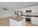 Kitchen featuring stainless steel appliances, an island, and light colored walls and cabinets at 236 Dog Leg Dr, Las Vegas, NV 89148