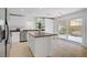 Bright kitchen featuring an island, stainless steel appliances, and sliding glass doors at 236 Dog Leg Dr, Las Vegas, NV 89148