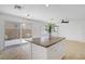Bright kitchen featuring an island, stainless steel appliances, and sliding glass doors to the backyard at 236 Dog Leg Dr, Las Vegas, NV 89148