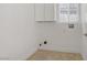 Well-lit laundry room with tile flooring, cabinet storage and washer/dryer hookups at 236 Dog Leg Dr, Las Vegas, NV 89148