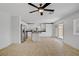 Bright living room featuring tile floors, a ceiling fan, and a sliding glass door to the backyard at 236 Dog Leg Dr, Las Vegas, NV 89148