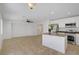 Open concept living room adjacent to kitchen with light colored walls, tile floors, and lots of light at 236 Dog Leg Dr, Las Vegas, NV 89148