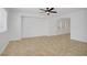 Neutral living room featuring tile floors, a ceiling fan, and an open floor plan at 236 Dog Leg Dr, Las Vegas, NV 89148