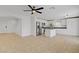 Bright living room featuring tile floors, a ceiling fan, and an open floor plan with a stairway at 236 Dog Leg Dr, Las Vegas, NV 89148