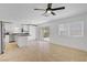 Bright living room featuring tile floors, a ceiling fan, and a sliding glass door to the backyard at 236 Dog Leg Dr, Las Vegas, NV 89148
