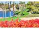 A picturesque pond with red flowers, lush greenery, and waterfront views at 236 Dog Leg Dr, Las Vegas, NV 89148