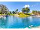 A scenic view of a pond surrounded by lush landscaping and vibrant aquatic plants at 236 Dog Leg Dr, Las Vegas, NV 89148