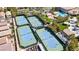 Aerial view of multiple tennis courts with green and blue surface and surrounding trees at 236 Dog Leg Dr, Las Vegas, NV 89148