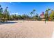 Community sand volleyball court for residents with manicured greenery and landscaping at 236 Dog Leg Dr, Las Vegas, NV 89148