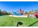 Community water park with winding slides, colorful towers, and lush green lawns at 236 Dog Leg Dr, Las Vegas, NV 89148