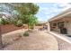 Spacious backyard featuring low-maintenance desert landscaping, a covered patio, and an outdoor dining area at 2413 Mourning Warbler Ave, North Las Vegas, NV 89084