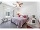 Bedroom with neutral colors, soft carpet, ceiling fan and window to bring in natural light at 2413 Mourning Warbler Ave, North Las Vegas, NV 89084