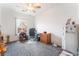 Cozy bedroom with neutral tones, ceiling fan, and a bright window providing natural light at 2413 Mourning Warbler Ave, North Las Vegas, NV 89084