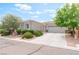 Charming single-story home featuring desert landscaping and a two-car garage at 2413 Mourning Warbler Ave, North Las Vegas, NV 89084