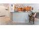 Open kitchen with breakfast bar, wood cabinets, and stainless steel appliances at 2413 Mourning Warbler Ave, North Las Vegas, NV 89084
