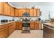 Kitchen featuring granite countertops, stainless steel appliances, and wooden cabinetry at 2413 Mourning Warbler Ave, North Las Vegas, NV 89084