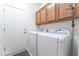 Practical laundry room with appliances, storage cabinets, and access to the outdoors at 2413 Mourning Warbler Ave, North Las Vegas, NV 89084