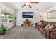 Living room with a ceiling fan, carpeted floors, and a comfortable brown sofa at 2413 Mourning Warbler Ave, North Las Vegas, NV 89084