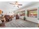 Cozy living room with plush carpet, large windows and comfortable seating, creating a relaxing atmosphere at 2413 Mourning Warbler Ave, North Las Vegas, NV 89084