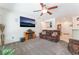 Comfortable living room area with a TV, sofa, and neutral decor at 2413 Mourning Warbler Ave, North Las Vegas, NV 89084