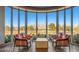 Bright lounge area features floor-to-ceiling windows with mountain views, offering a serene and inviting atmosphere at 2413 Mourning Warbler Ave, North Las Vegas, NV 89084