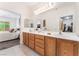 Main bathroom with double sinks, vanity, and access to a walk-in closet and main bedroom at 2413 Mourning Warbler Ave, North Las Vegas, NV 89084
