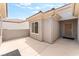 Private outdoor patio area with a security door and neutral color scheme at 2413 Mourning Warbler Ave, North Las Vegas, NV 89084