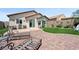 The backyard boasts a brick patio, lush lawn, and comfortable seating perfect for relaxing or entertaining guests at 2425 Sturrock Dr, Henderson, NV 89044
