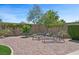 Relaxing backyard featuring artificial grass, a brick patio, and comfortable seating arrangements at 2425 Sturrock Dr, Henderson, NV 89044