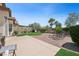 An inviting backyard features a manicured lawn, mature trees, and ample patio space for outdoor enjoyment at 2425 Sturrock Dr, Henderson, NV 89044