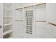 Walk-in closet with shelving and wooden rods providing optimal organization for clothing and accessories at 2425 Sturrock Dr, Henderson, NV 89044