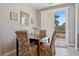 Dining room with a dark wood table and upholstered chairs, near a sliding door at 2425 Sturrock Dr, Henderson, NV 89044