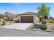 Inviting single-story home with a well-kept front yard and a convenient two-car garage at 2425 Sturrock Dr, Henderson, NV 89044