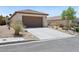 Beautiful one-story home with a two-car garage, desert landscaping, and a long driveway at 2425 Sturrock Dr, Henderson, NV 89044