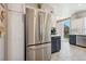 Bright eat-in kitchen featuring modern stainless steel appliances, stylish cabinetry, and convenient access to the backyard at 2425 Sturrock Dr, Henderson, NV 89044