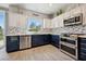Kitchen with stainless steel appliances, bright white countertops and two-tone cabinets at 2425 Sturrock Dr, Henderson, NV 89044