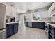 Bright kitchen with two-tone cabinets, stainless steel appliances, and a backyard view at 2425 Sturrock Dr, Henderson, NV 89044