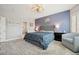 Serene bedroom with natural light, a plush bed, stylish furniture, and calming blue accent wall at 2425 Sturrock Dr, Henderson, NV 89044
