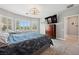 This main bedroom boasts natural light, stylish furniture, and an en-suite bathroom at 2425 Sturrock Dr, Henderson, NV 89044