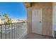 This cozy balcony shows a peek of neighboring units and palm trees at 251 S Green Valley Pkwy # 2821, Henderson, NV 89012