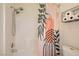 Modern bathroom with shower featuring attractive curtain and a convenient storage shelf at 251 S Green Valley Pkwy # 2821, Henderson, NV 89012