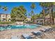 Sparkling community pool with lounge chairs surrounded by lush landscaping at 251 S Green Valley Pkwy # 2821, Henderson, NV 89012
