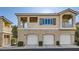 Charming condo featuring a three-car garage and a beige stucco facade with orange roofing at 251 S Green Valley Pkwy # 2821, Henderson, NV 89012
