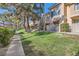 Exterior view of condos with well-maintained lawn and mature trees at 251 S Green Valley Pkwy # 2821, Henderson, NV 89012
