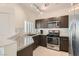 Kitchen with stainless steel appliances, granite countertops, and white tile backsplash at 251 S Green Valley Pkwy # 2821, Henderson, NV 89012