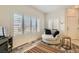 Bright living room features shutter-style blinds, neutral paint, wood floors, and a barrel style chair at 251 S Green Valley Pkwy # 2821, Henderson, NV 89012