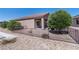 Backyard with desert landscaping, wrought-iron fencing and a covered patio at 2538 Capella Star St, Henderson, NV 89044